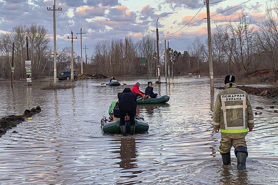 In this photo taken and released by the Administration of the city of Orenburg telegram channel on Friday, April 5, 2024, people use boats while evacuating after a part of a dam burst causing flooding, in Orsk, Russia. (Administration of the city of Orenburg Telegram Channel via AP)