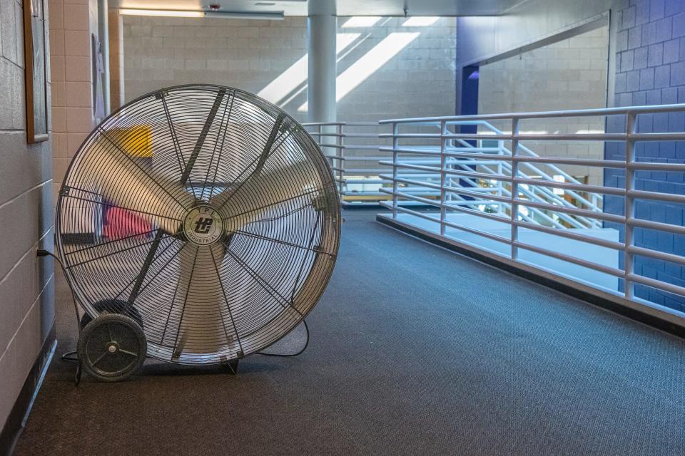 A large fan sits in a second-floor hallway at Fort Collins High School Tuesday in Fort Collins. Because the school does not have a working air conditioning system, fans are used in classrooms and hallways to circulate air on hot days.