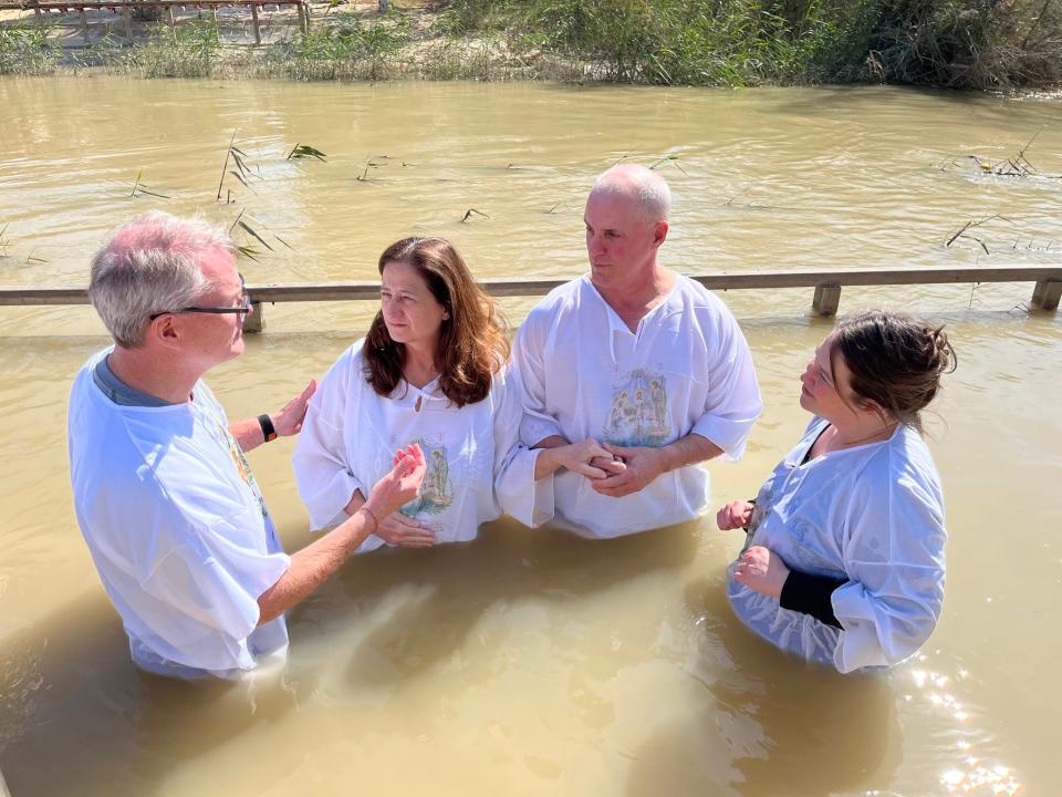 Dana and Heath Soehn, center, renew their baptisms in the Jordan River by the Rev. Adam Hamilton, senior pastor of the United Methodist Church of the Resurrection, and Anne Williams, pastor at the Church of the Resurrection in Leawood, Kansas.