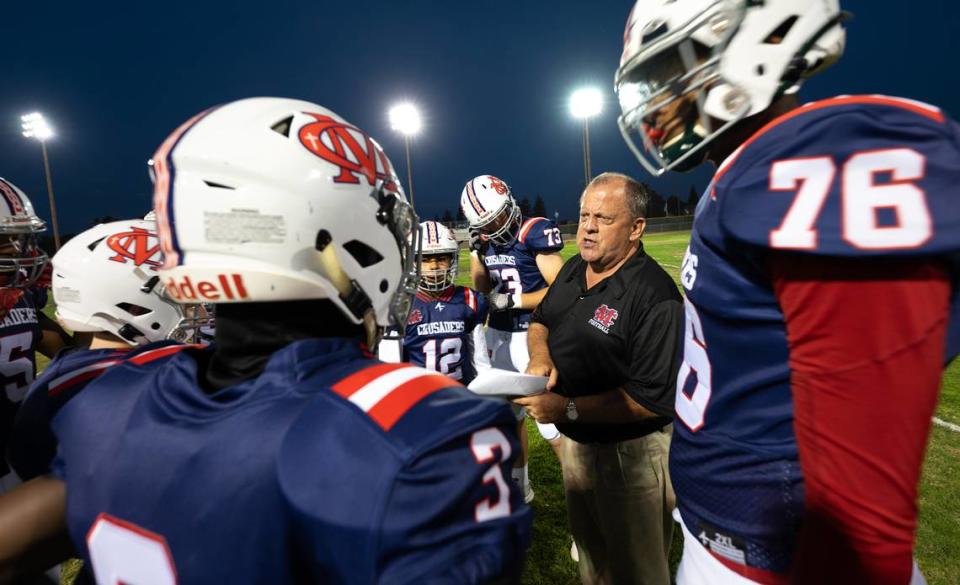 Modesto Christian coach Kurt Bryan talks with his players at the start of the game with Stone Ridge Christian at Modesto Christian High School in Salida, Calif., Friday, Sept. 15, 2023.