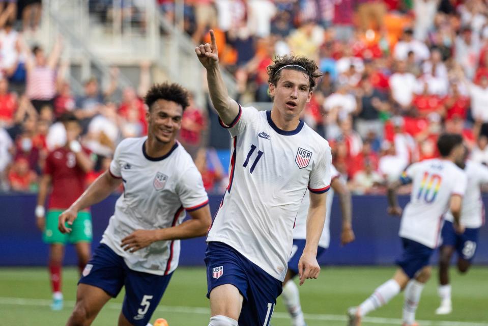 United States forward Brenden Aaronson (11) celebrates his goal with fullback Antonee Robinson (5) during a June match against Morocco in Cincinnati. The American team returns to the World Cup for men's soccer after missing out in 2018.