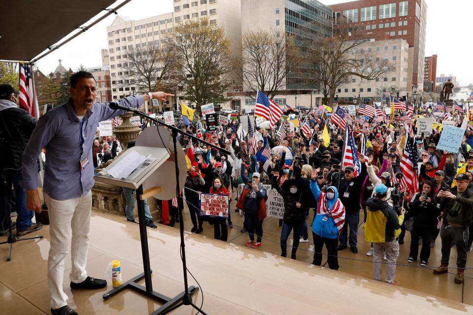 In this file photo taken on April 30, 2020, Ryan Kelley, a protest organizer, for the  American Patriot Rally organized by the Michigan United for Liberty for the reopening of businesses stands on the steps of the Michigan State Capitol in Lansing, Michigan. - The FBI arrested Kelley, leading Republican candidate for governor, June 9, 2022, in Michigan on charges of participating in the January 6, 2021 assault on the US Capitol by supporters of then-president Donald Trump. The Justice Department said Kelley took part in the violent attack on the Capitol that aimed to halt the certification of Democrat Joe Biden's victory over Trump in the presidential election two months earlier.