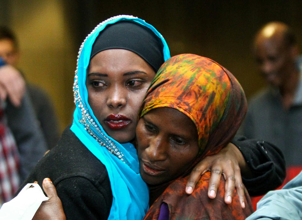 A family member embraces Safiya Hassan, a refugee from Somalia, at the airport in Boise, Idaho, on March 10. (Photo: Brian Losness/Reuters)