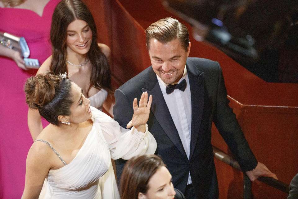 Camila Morrone, Salma Hayek, and Leonardo DiCaprio talk on the red carpet