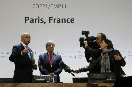 French Minister of Foreign Affairs Laurent Fabius, President-designate of COP21, (L) and Peru's Minister of Environment Manuel Pulgar Vidal talk to a tv crew as they visit a conference room on the site of the World Climate Change Conference 2015 (COP21) in Le Bourget, near Paris, France, November 29, 2015. REUTERS/Jacky Naegelen