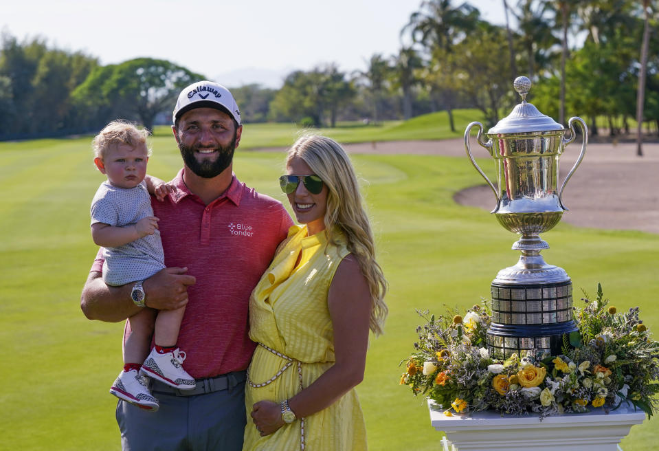 FILE - Jon Rahm, of Spain, poses for photos with his wife Kelley and his son Kepa, after winning the Mexico Open at Vidanta, in Puerto Vallarta, Mexico, May 1, 2022. Kelley says she knew so little about golf when they met that she thought Rahm was the worst player on Arizona State's team. (AP Photo/Eduardo Verdugo, File)