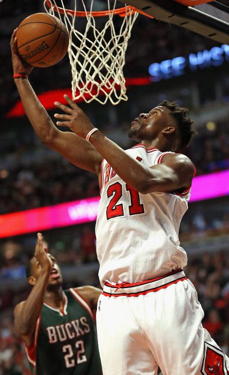 Chicago Bulls' Jimmy Butler goes up for a shot over Milwaukee Bucks' Khris Middleton on his way to a game-high 31 points during the first round of the NBA Playoffs at United Center on April 20, 2015