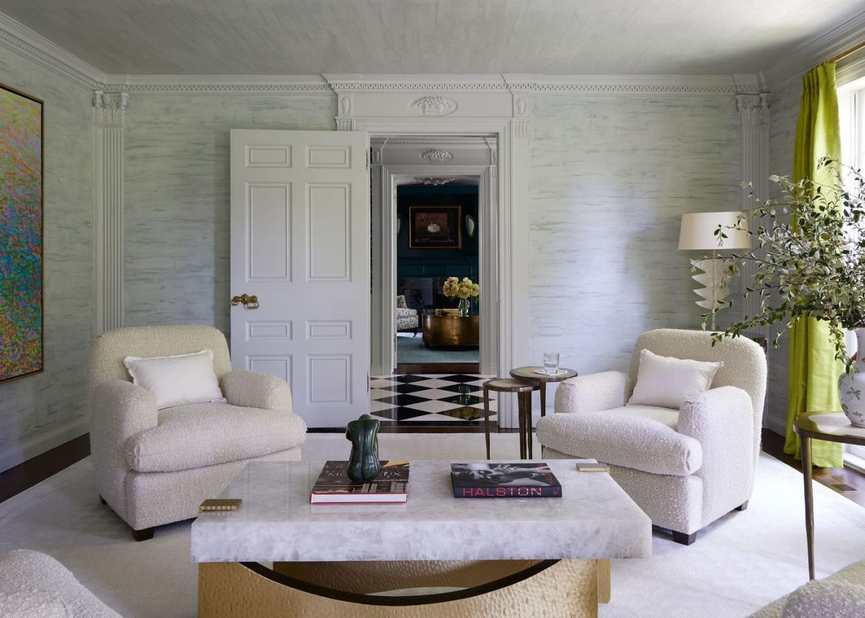 a living room with white furniture