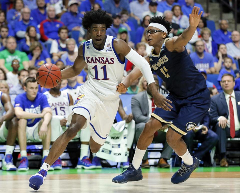 Kansas' Josh Jackson (11) drives the baseline to the basket for a shot as UC Davis forward Chima Moneke, right, defends in the second half of a first-round game in the men's NCAA college basketball tournament in Tulsa, Okla., Friday March 17, 2017. (AP Photo/Tony Gutierrez)