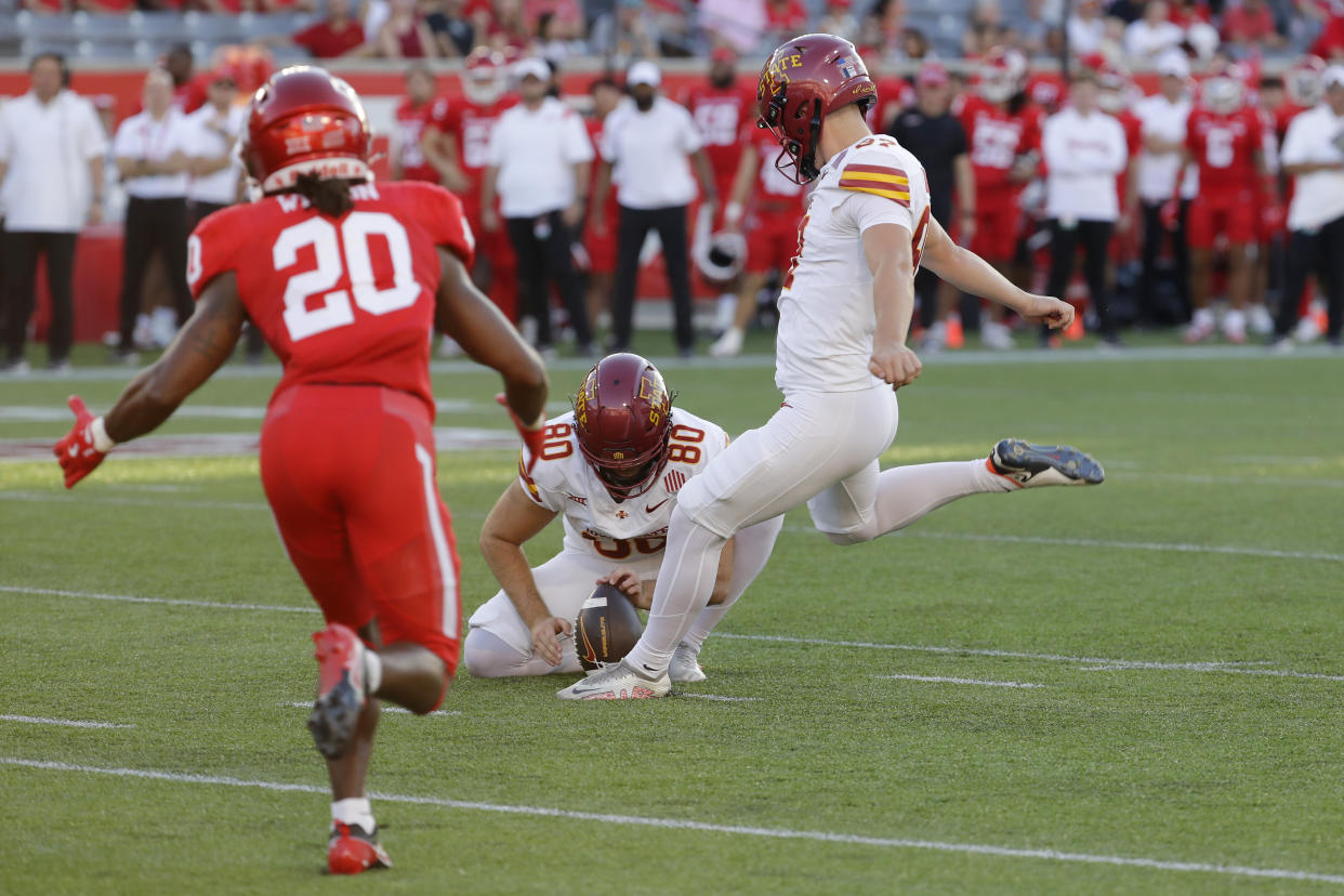 Iowa State place kicker Kyle Konrardy, right, kicks a field goal off of holder Tyler Perkins (80) as Houston defensive back Jeremiah Wilson (20) closes in during the first half of an NCAA college football game, Saturday, Sept. 28, 2024, in Houston. (AP Photo/Michael Wyke)