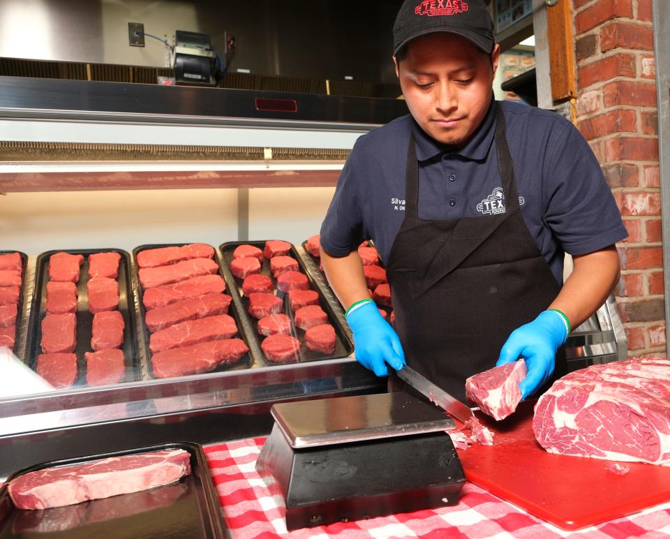 Texas Roadhouse employee and National Meat Cutting Challenge finalist Silvano Vicente cuts steaks on Feb. 7 at the restaurant's north Oklahoma City location.