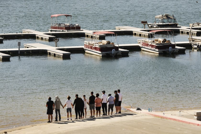 PIRU, CA - JULY 13: Cast members from the TV Show "Glee" and friends held hands as they shouted "Say her name - Naya" as they gathered on the Lake Piru boat launch Monday morning just as Ventura County Sheriff's Search and Rescue dive team located a body Monday morning in Lake Piru as the search continued for 33-year-old "Glee" actress Naya Rivera after her 4-year-old son was found alone on a boat she rented last Wednesday. Rivera rented the pontoon boat and had been swimming with her son who was the last one to see her before she went missing. The boy got back into the boat after a swim but his mother did not follow. Lake Piru on Monday, July 13, 2020 in Piru, CA. (Al Seib / Los Angeles Times)