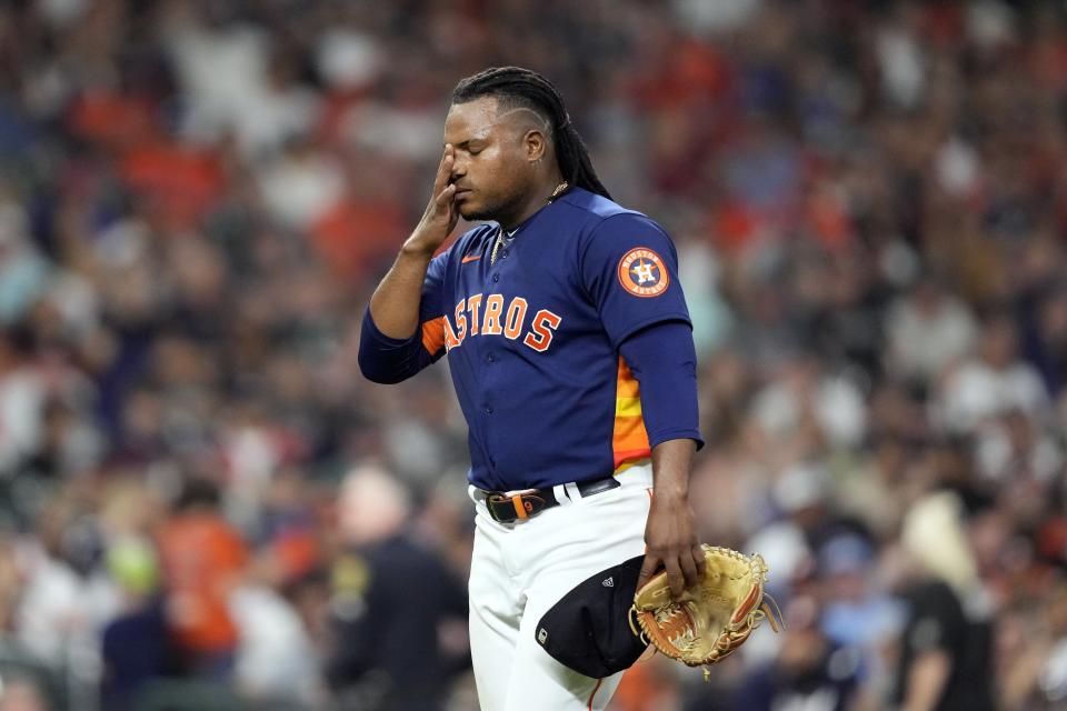 Houston Astros starting pitcher Framber Valdez wipes his face after being pulled from the baseball game during the seventh inning against the Texas Rangers Sunday, April 16, 2023, in Houston. (AP Photo/David J. Phillip)