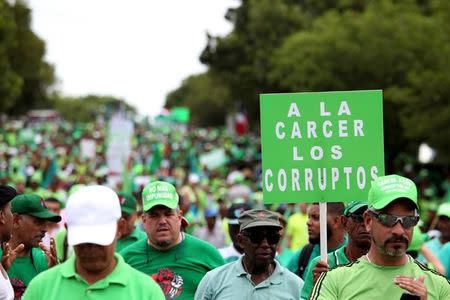 People march during a protest against corruption and the Brazilian conglomerate Odebrecht SA, in Santo Domingo, Dominican Republic, July 16, 2017. The sign reads "To the jail the corrupt " REUTERS/Ricardo Rojas