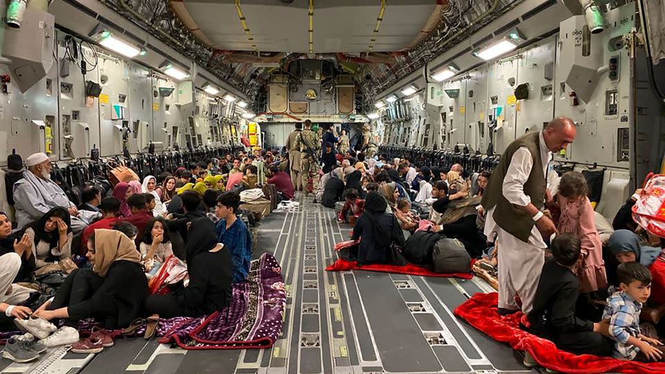 Afghan people sit inside a US military aircraft on August 19, 2021, following the Taliban's takeover of Afghanistan. - Shakib Rahmani/AFP/Getty Images