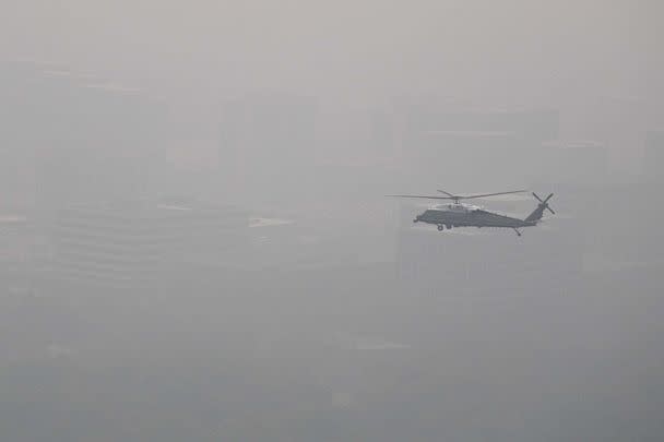 PHOTO: Marine One with President Joe Biden flies over a hazy Chicago, June 28, 2023, as some 80 million people from the Midwest to the East Coast are under air quality alerts due to smoke from Canadian wildfires sweeping the nation. (Andrew Caballero-Reynolds/AFP via Getty Images)