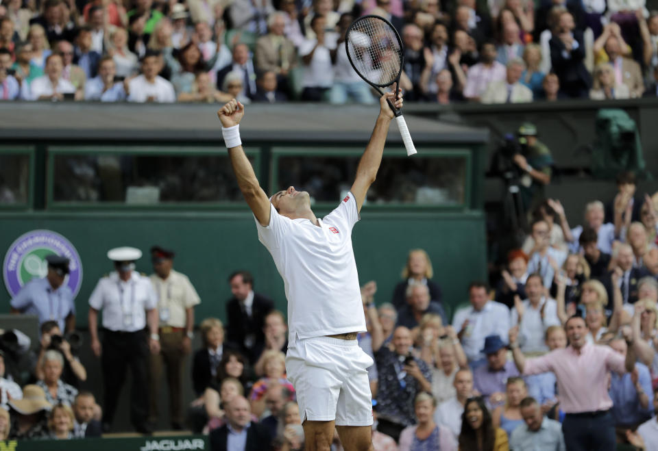 Switzerland's Roger Federer celebrates defeating Spain's Rafael Nadal during a men's singles semifinal match on day eleven of the Wimbledon Tennis Championships in London, Friday, July 12, 2019. (AP Photo/Ben Curtis)