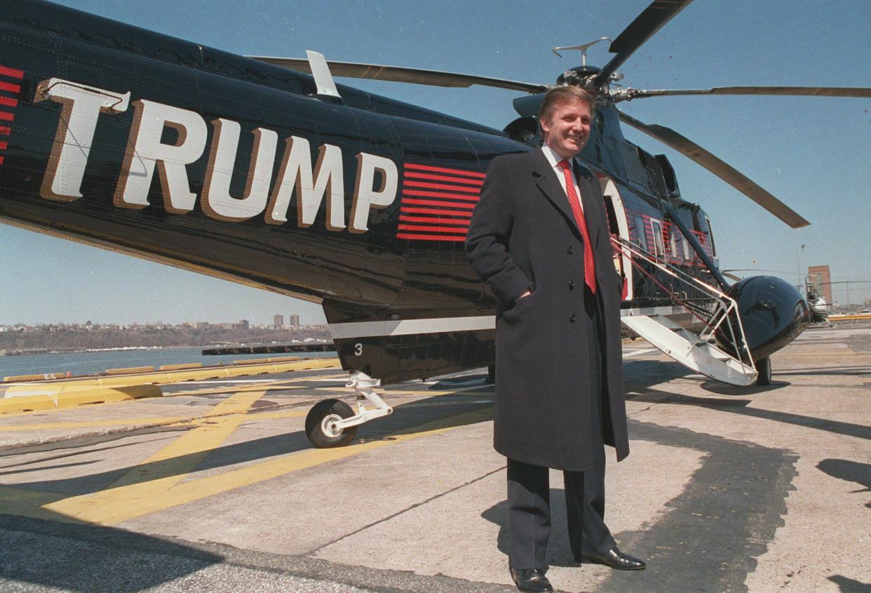 Donald Trump stands next to one of his three Sikorsky helicopters at New York Port Authority's West 30 Street Heliport in March 1988.