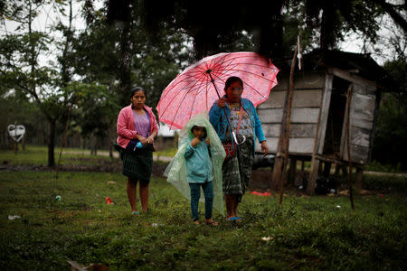 Local residents arrive at a service for Jakelin Caal, a 7-year-old girl who handed herself in to U.S. border agents earlier this month and died after developing a high fever while in the custody of U.S. Customs and Border Protection, at her home village of San Antonio Secortez, in Guatemala December 24, 2018. Picture taken December 24, 2018. REUTERS/Carlos Barria