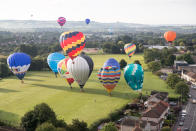 <p>Hot air balloons take to the skies as they participate in the mass assent at sunrise on the second day of the Bristol International Balloon Fiesta on August 11, 2017 in Bristol, England. (Photo: Matt Cardy/Getty Images) </p>