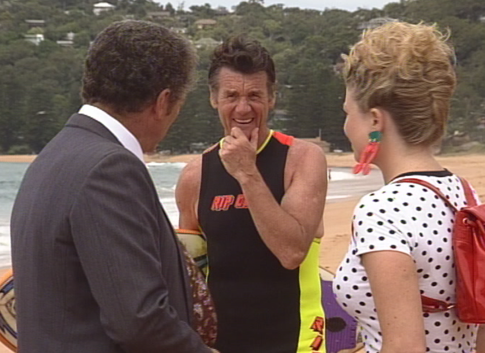 home and away, michael palin surfing on the beach