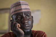 Father Kabiru Sani Jangebe, who has three daughters amongst the more than 300 girls abducted from their boarding school on Friday, waits for news at the school in Jangebe town, Zamfara state, northern Nigeria Saturday, Feb. 27, 2021. Nigerian police and the military have begun joint operations to rescue the more than 300 girls who were kidnapped from the Government Girls Junior Secondary School, according to a police spokesman. (AP Photo/Ibrahim Mansur)