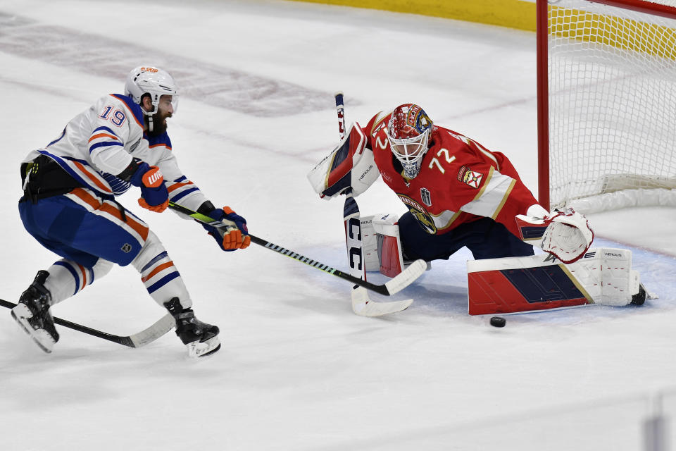 Florida Panthers goaltender Sergei Bobrovsky (72) defends the goal against Edmonton Oilers center Adam Henrique (19) during the first period of Game 1 of the NHL hockey Stanley Cup Finals, Saturday, June 8, 2024, in Sunrise, Fla. (AP Photo/Michael Laughlin)