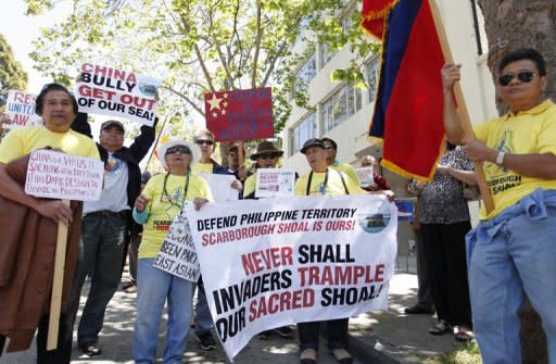 Protesters outside the Consulate General of China in San Francisco in May oppose a territorial dispute over the Scarborough Shoal, an outcrop in the South China Sea about 230 km from the Philippines' main island of Luzon. China's official Xinhua news agency on Saturday accused US Secretary of State Hillary Clinton of "meddling" in the South China Sea territorial disputes