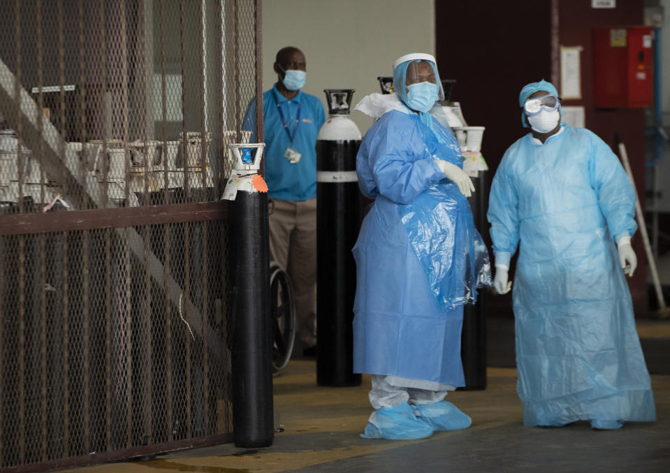 Health workers in protective suits in a makeshift emergency unit at Steve Biko Academic Hospital in Pretoria, South Africa, Monday, Jan. 11, 2021, which is battling an ever-increasing number of Covid-19 patients. (AP Photo/Themba Hadebe)