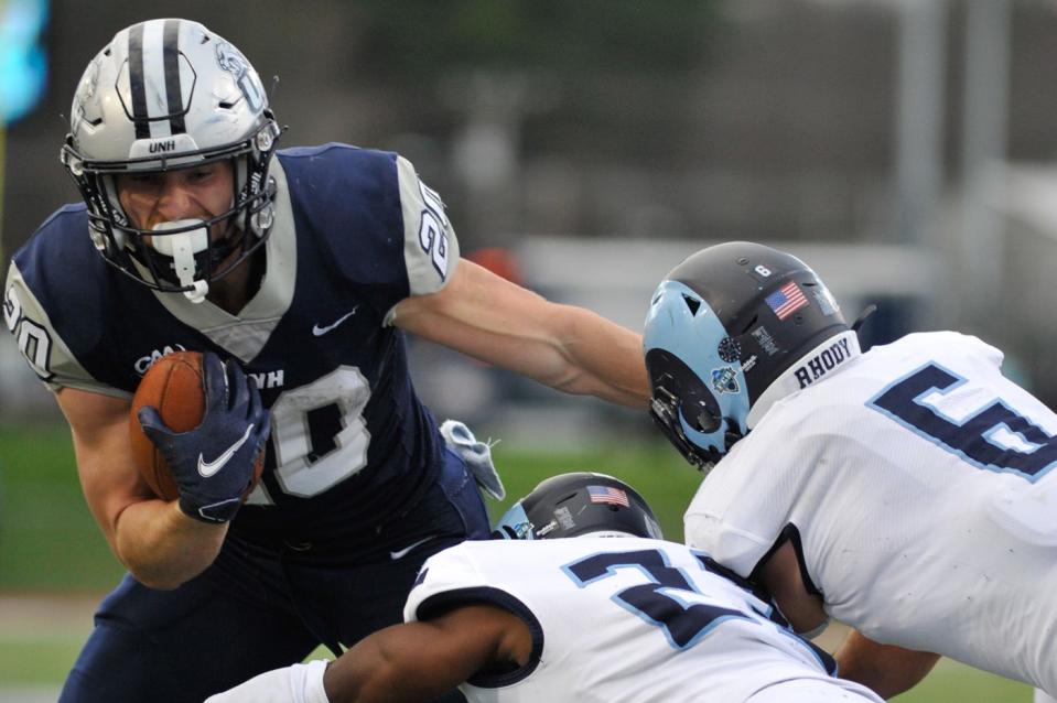 The University of New Hampshire's Dylan Laube carries the ball against Rhode Island Nov. 12, 2022.