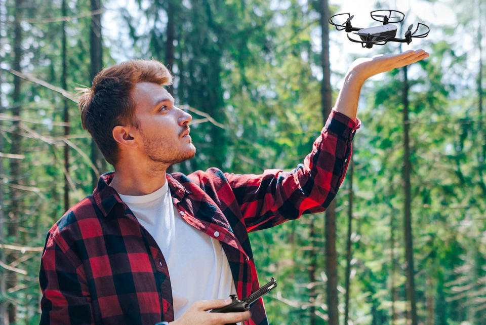 A man flying a compact Potensic Elfin Mini drone with a 2K camera