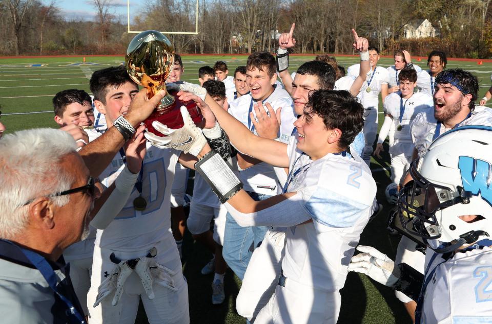 Westlake players celebrate with the gold ball after defeating Dobbs Ferry in the Section 1 Class C championship game at Mahopac High School Nov. 12, 2022. 