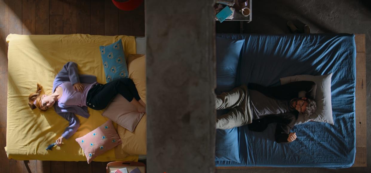  Valentina and David lie on their beds separated by a wall. 