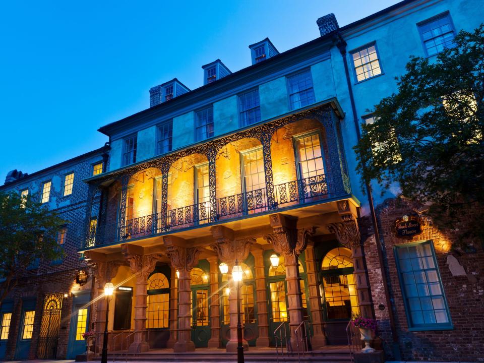 The Dock Street Theatre in Charleston, South Carolina, lit up at night.