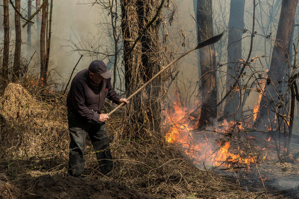 Image: A forest ranger with the Poliskyi Distrcit State Forestry Agency prevents the spread of a fire near Krasiatychi, Kyiv region (Oksana Parafeniuk / for NBC News)