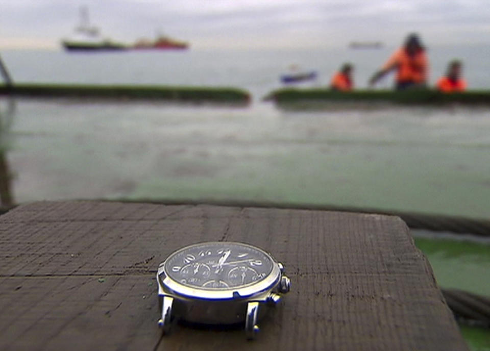 In this frame grab made available by Russian Rossiya One TV Channel on Wednesday, Dec. 28, 2016 a wristwatch lifted by divers is recovered, outside Sochi, Russia. (Rossiya One TV Channel photo via AP)