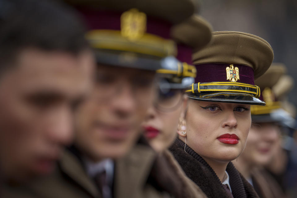 Romanian military cadets stand in formation before the National Day parade in Bucharest, Romania, Friday, Dec. 1, 2023. Tens of thousands of people turned out in Romania's capital on Friday to watch a military parade that included troops from NATO allies to mark the country's National Day. (AP Photo/Vadim Ghirda)