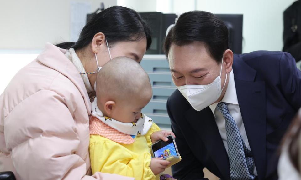 President Yoon with a baby during a visit to a hospital in Seoul.