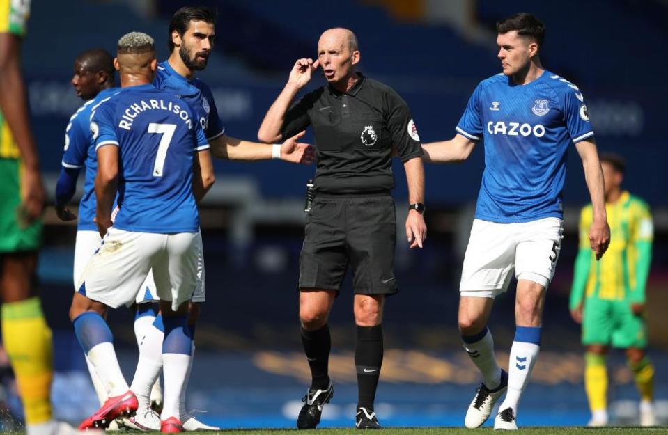 Everton’s Andre Gomes, Michael Keane and Richarlison look on as Mike Dean awaits the conclusion of a VAR review before reinstating Dominic Calvert-Lewin’s first goal at West Brom