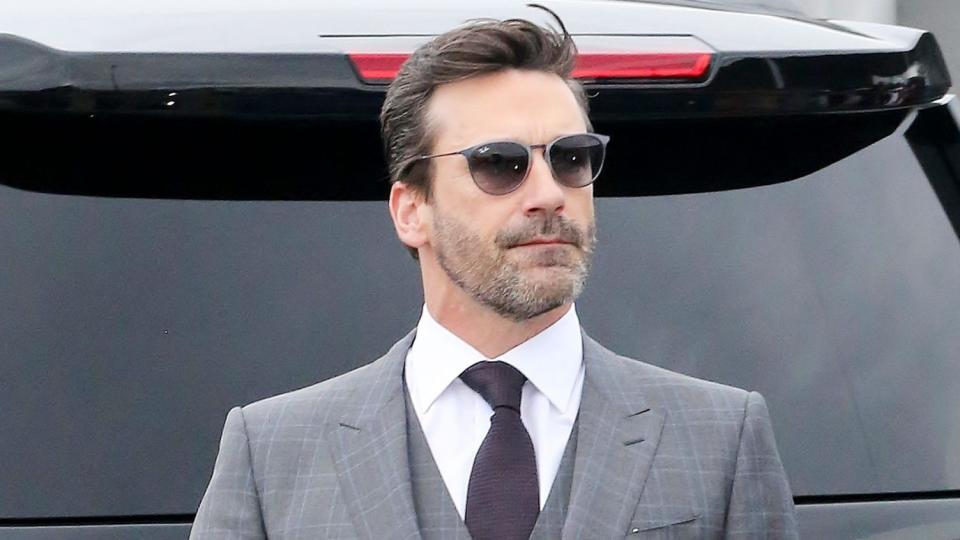 <p>Jon Hamm's coffee is the perfect accessory for his three-piece suit. </p>