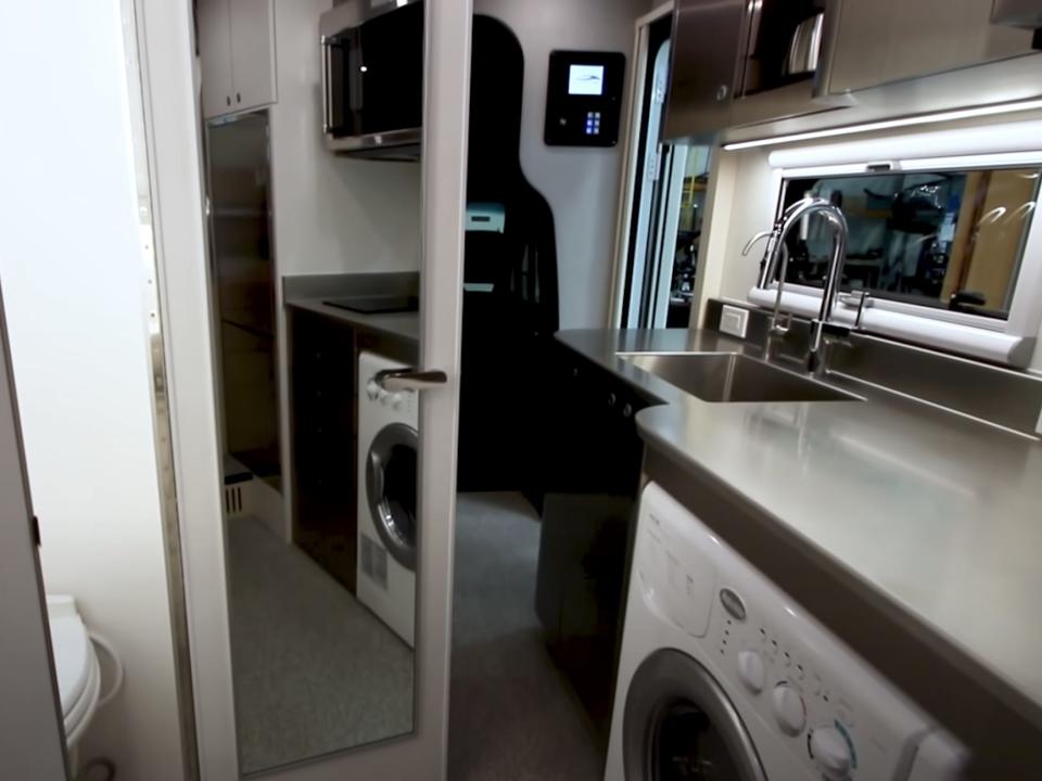 an open bathroom door next to the washer and dryer