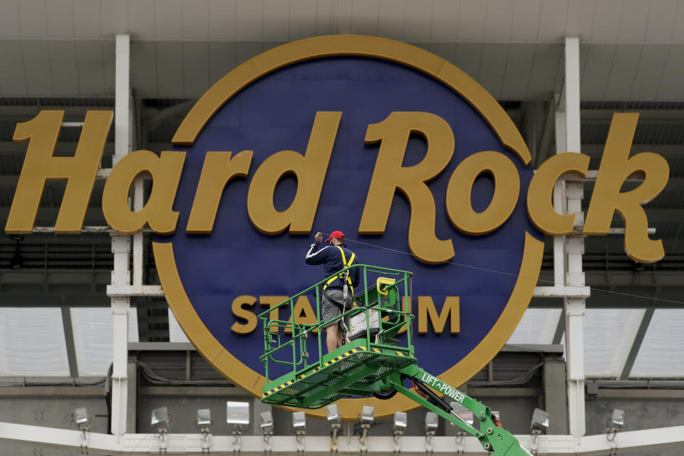 A worker strings wire outside of the Hard Rock Stadium Monday, Jan. 27, 2020, in Miami Gardens, Fla. in preparation for the NFL Super Bowl 54 football game. (AP Photo/Chris Carlson)