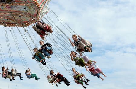 Visitors ride a merry-go-round during the opening day of the 181st Oktoberfest in Munich September 20, 2014. REUTERS/Lukas Barth