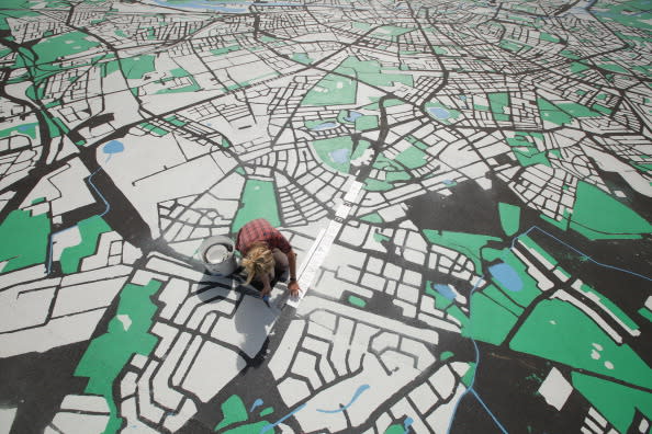 Landscape architect Lisa Hankow paints a giant map of Berlin in the city center on August 6, 2012 in Berlin, Germany. The map, which will measure 50 meters X 50 meters when finished, is in the scale of 1:775 and is an art installation meant to coincide with 775th anniversary of Berlin, which the city will celebrate in October. (Photo by Sean Gallup/Getty Images)