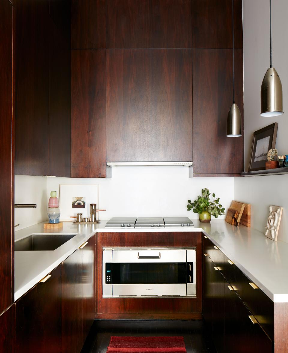 When Otero first saw the apartment, it had very low ceilings, so he opened everything and made the cabinets in the kitchen go all the way up, giving an element of drama plus handy added storage. The countertops are made of Corian; the brass pulls are from Wainlands; the cooktop and oven are from Gaggenau; and the faucet is from Blanco.