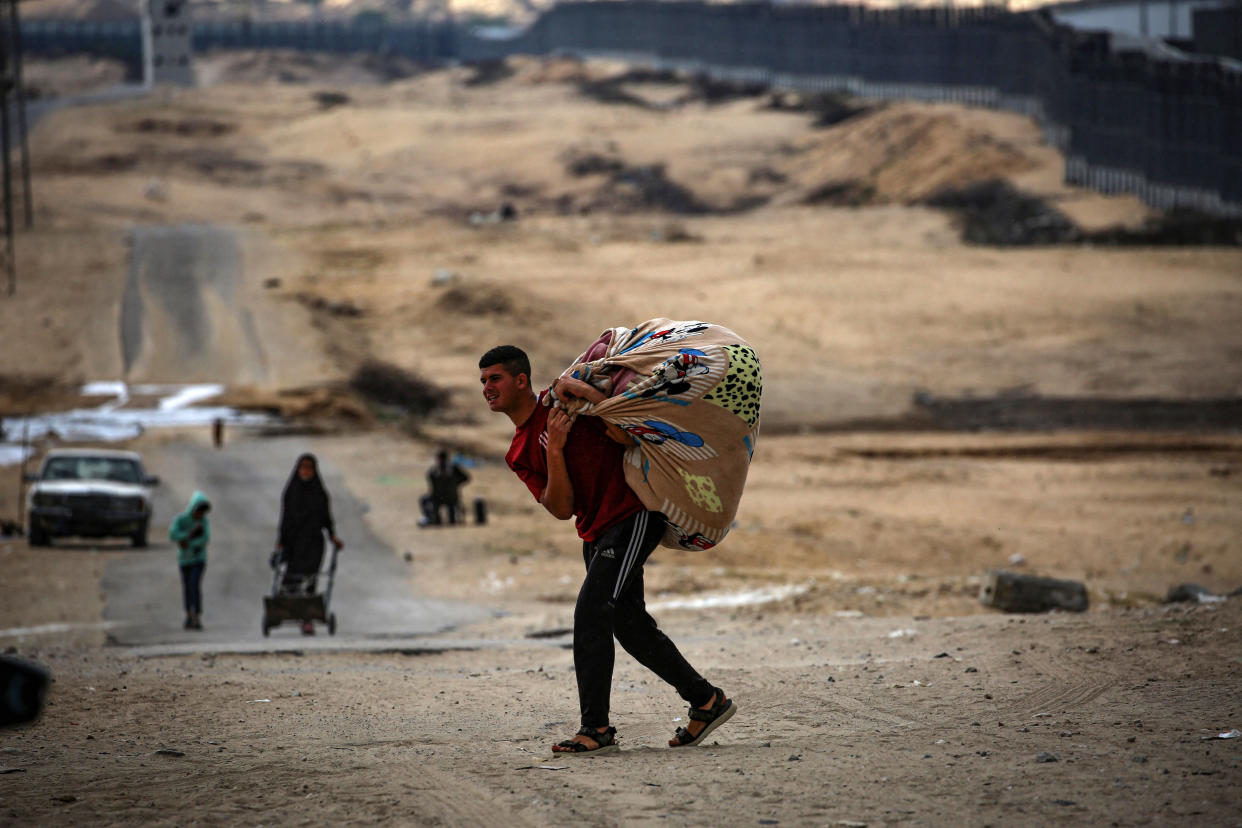 Palestinians carry their belongings as they prepare to flee Rafah, in the southern Gaza Strip, May 13, 2024, amid the ongoing conflict between Israel and Hamas. / Credit: AFP via Getty