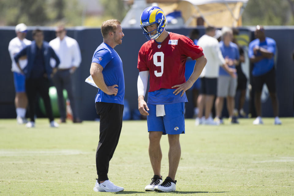 Los Angeles Rams head coach Sean McVay, left, talks to quarterback Matthew Stafford during NFL football practice Monday, July 25, 2022, in Irvine, Calif. (AP Photo/Kyusung Gong)