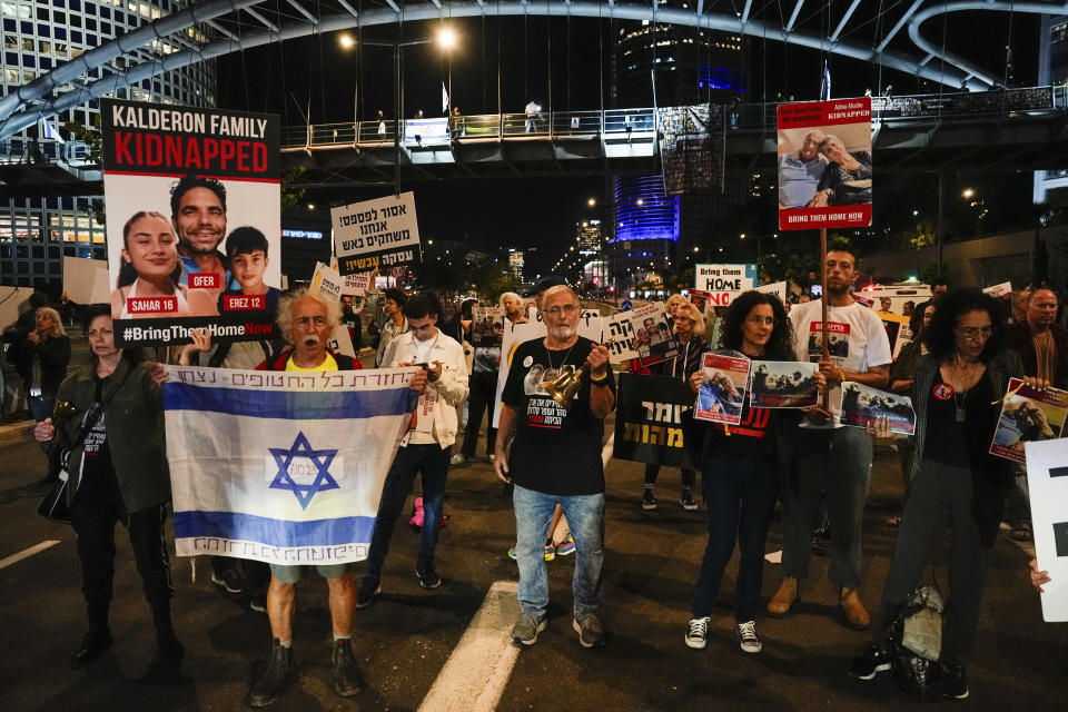 Families and friends of about 240 hostages held by Hamas in Gaza call for Israeli Prime Minister Benjamin Netanyahu to bring them home during a demonstration in Tel Aviv, Israel Tuesday, Nov. 21, 2023. Israel's Cabinet was convening Tuesday to consider a possible deal for the release of some of the hostages held by Hamas in exchange for a temporary halt to Israel's military offensive in Gaza. Hamas captured the hostages in an Oct. 7 cross-border attack that killed at least 1,200 people and triggered an Israeli invasion of Gaza. (AP Photo/Ariel Schalit)