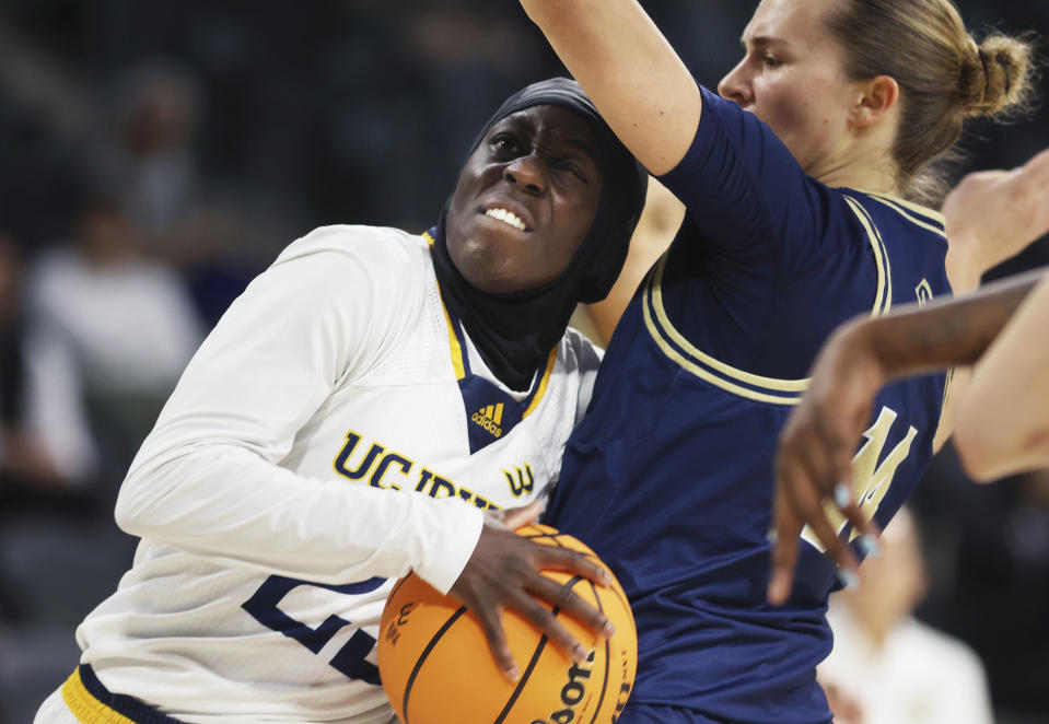 UC Irvine's guard Diaba Konate (23) and UC Davis' guard Tova Sabel (14) collide under the net during the second half of an NCAA college basketball game in the championship of the Big West Conference women's tournament Saturday, March 16, 2024, in Henderson, Nev. (AP Photo/Ronda Churchill)