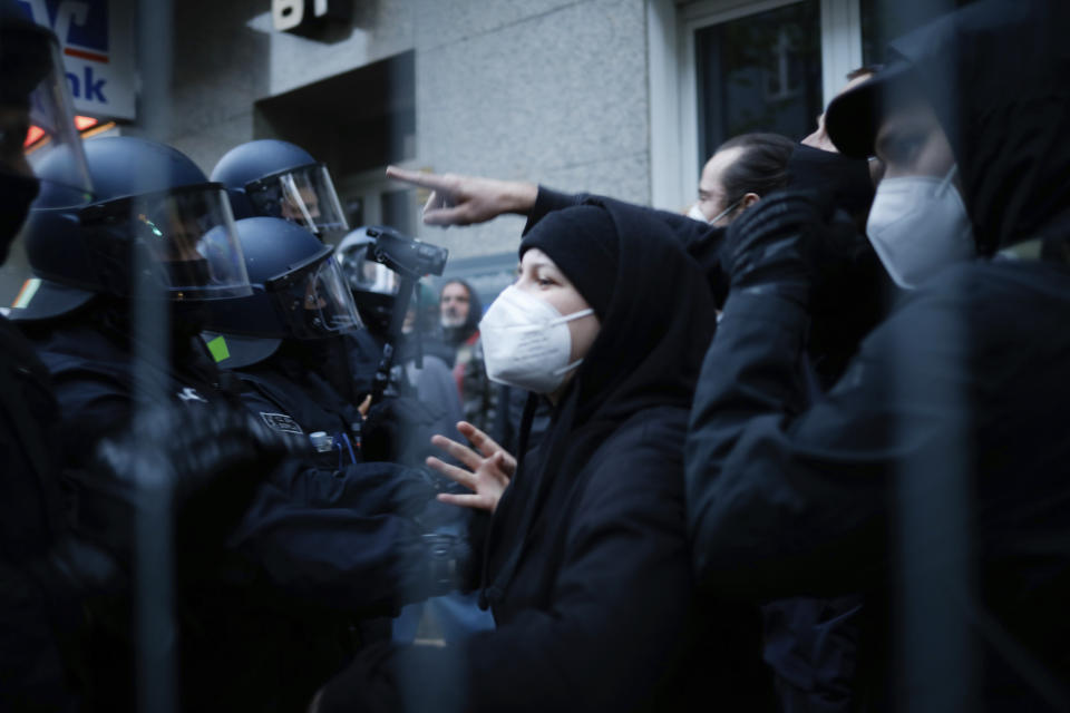 Police officers face with demonstrators during a May Day rally in Berlin, Germany, Saturday, May 1, 2021. (AP Photo/Markus Schreiber)